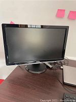 Dell 22-inch monitor with black glossy frame and circular stand on desk