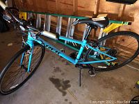 Full side view of the bike leaning against garage wall