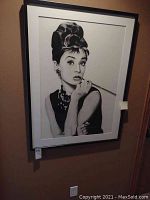 Frontal view of framed Audrey Hepburn portrait showing full frame and mat.