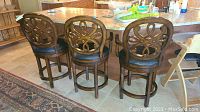 Three barstools lined up at kitchen island showing overall appearance