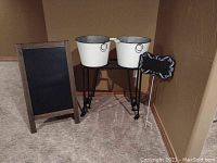 Full view of wooden framed chalkboard sandwich board, metal tubs on rolling metal stand, and small chalkyard sign.