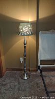 Full view of the floor lamp with blue and white printed shade
