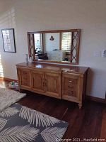 Full frontal view of dresser base topped by matching mirror in a bedroom setting