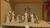 Overview of full set of fourteen resin nativity figurines on shelf