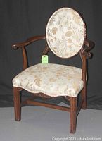 Front view of the chair showing oval back and ball-and-claw arms