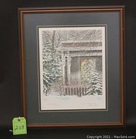 Framed Christmas Eve print by Carol Black showing a snowy winter porch scene with a lit window and snow-covered trees.