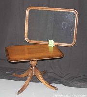 Side/coffee table with removable wood-framed glass tray top, turned and carved pedestal base with brass feet, shown with glass tray removed and placed behind for detail.