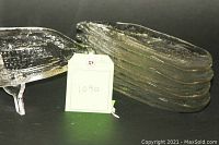 Stack of 8 clear glass corn cob plates with one plate displayed on a clear stand.