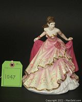 Front view of Royal Doulton Grace figurine showing the detailed flowing pink dress with gold trim and floral accents.