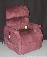 Front angled view of burgundy fabric recliner chair in upright position.