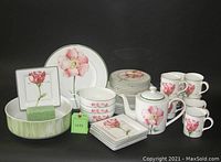 Full set arrangement showing plates, bowls, mugs, saucers, square plates, oval bowl, teapot