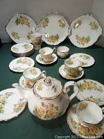 Overview of entire 27-piece tea set arranged on table
