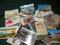 Photo showing a variety of postcards with holiday themes, scenic views, and artistic designs.