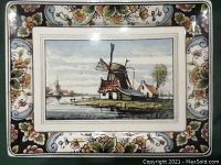 Front of the wall plate showing hand-painted windmill scene and floral border