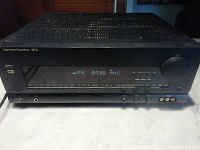 Front view of the Harman Kardon AVR65 receiver showing model number and front controls.