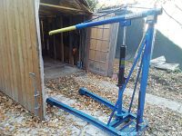 Full view of hoist showing frame, hydraulic jack, boom and base