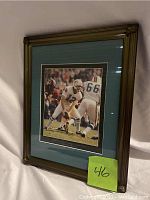 Framed photograph of Miami Dolphins players in 1973 Super Bowl action with green mat and gold-tone frame.