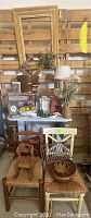Full view of lot showing chairs, bucket, frame, baskets, ceramic dishes, small stools, cinnamon broom, wire crate and shelving display