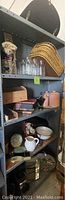 Shelving unit with bamboo placemats, mason jars, ceramic canisters and small decorative items
