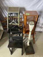 Full view showing doctors scale, stools, step ladder, spice rack, and small table clustered together