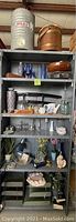 Shelf showing vintage Igloo cooler, antique wooden bucket, decorative Japanese katanas, glass and ceramic items