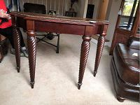 Full side view showing twisted spiral legs and sturdy wooden structure.