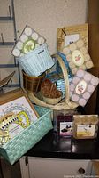 Group photo showing various baskets, multiple packs of Root brand candles with different scents, and picture frames with decorative motifs.