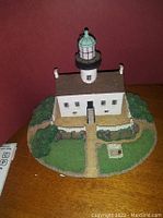 Front view of the Danbury Mint Old Point Loma lighthouse resin model showcasing the hand-painted details and landscaped base.