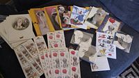 Photo shows multiple dog-themed greeting cards, sticker sheets with Old English Sheepdog design, and various sticky note pads.