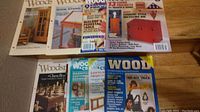 Photo showing various woodworking magazines arranged on a shelf including Woodcraft, Woodsmith, and Wood titles.