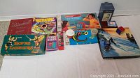 Full lot of various classic and vintage board and card games spread out on a white surface.