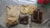 Top view of the group showing wooden box with tools, burlap sack, two canvas pouches, and leather pouch