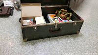 Vintage toy collection inside large green vintage trunk