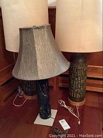 Front view of Sonneman stone base lamp with grey shade and two matching ceramic lamps