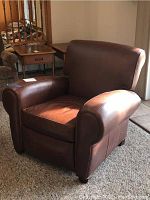 Front view of recliner showing seat cushion and rolled arms