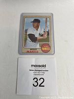 Front of card in plastic sleeve with auction marker