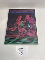 Front cover of 1972 Super Bowl VII program with black holographic football player illustrations and title.
