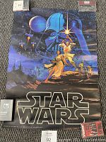 Full view of the classic 1977 Star Wars poster showing main characters and background elements