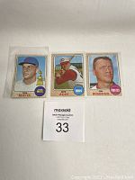 Three 1968 Topps baseball cards laid flat including Tom Seaver, Pete Rose, and Jim Bunning.
