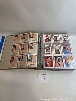 Full binder opened showing two pages with nine collectible non-sport cartoon cards each, including 'Fievel Goes West' characters.