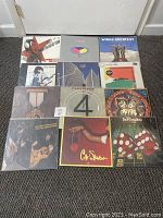 Full lot of 12 classic rock vinyl records laid out on floor, showing album cover art and overall condition.
