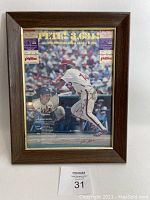 Frontal view of framed autographed photo of Pete Rose with two Phillies ticket stubs and Stan Musial inset visible