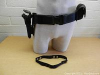 Front view of the HCW holster belt on a mannequin showing the holster, pouch, and black adjustable strap placed in front.