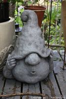 Concrete garden gnome statue showing size, shape, and details