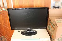 Samsung 27-inch SyncMaster TV showing remote on oval base stand with visible scratches on screen.