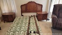 Photo showing the queen bed frame with wood and cane headboard, mattress, and nightstands in room setting
