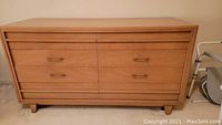 Full front view of light wood 6-drawer dresser showing overall design and metal handles