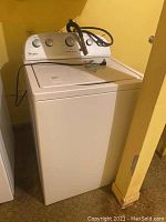 Front view of white Whirlpool top-load washer showing overall condition