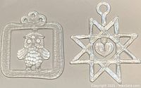 Pair of vintage Kosta Boda Christmas glass ornaments, star with heart and owl in square frame.