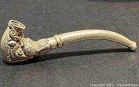 Side view of 4 inch silver pipe featuring dragon detail on the bowl and stem